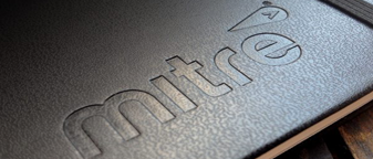 Debossed logo pressed into dark material